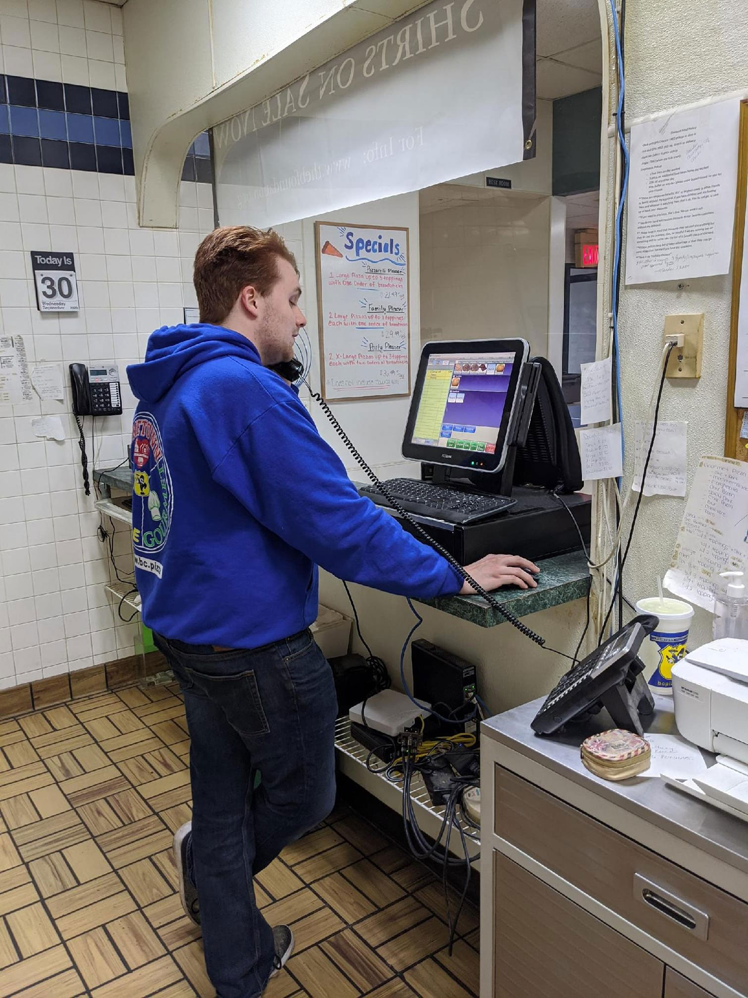 Man taking order on POS at BC Pizza