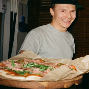 Man holding pizza out